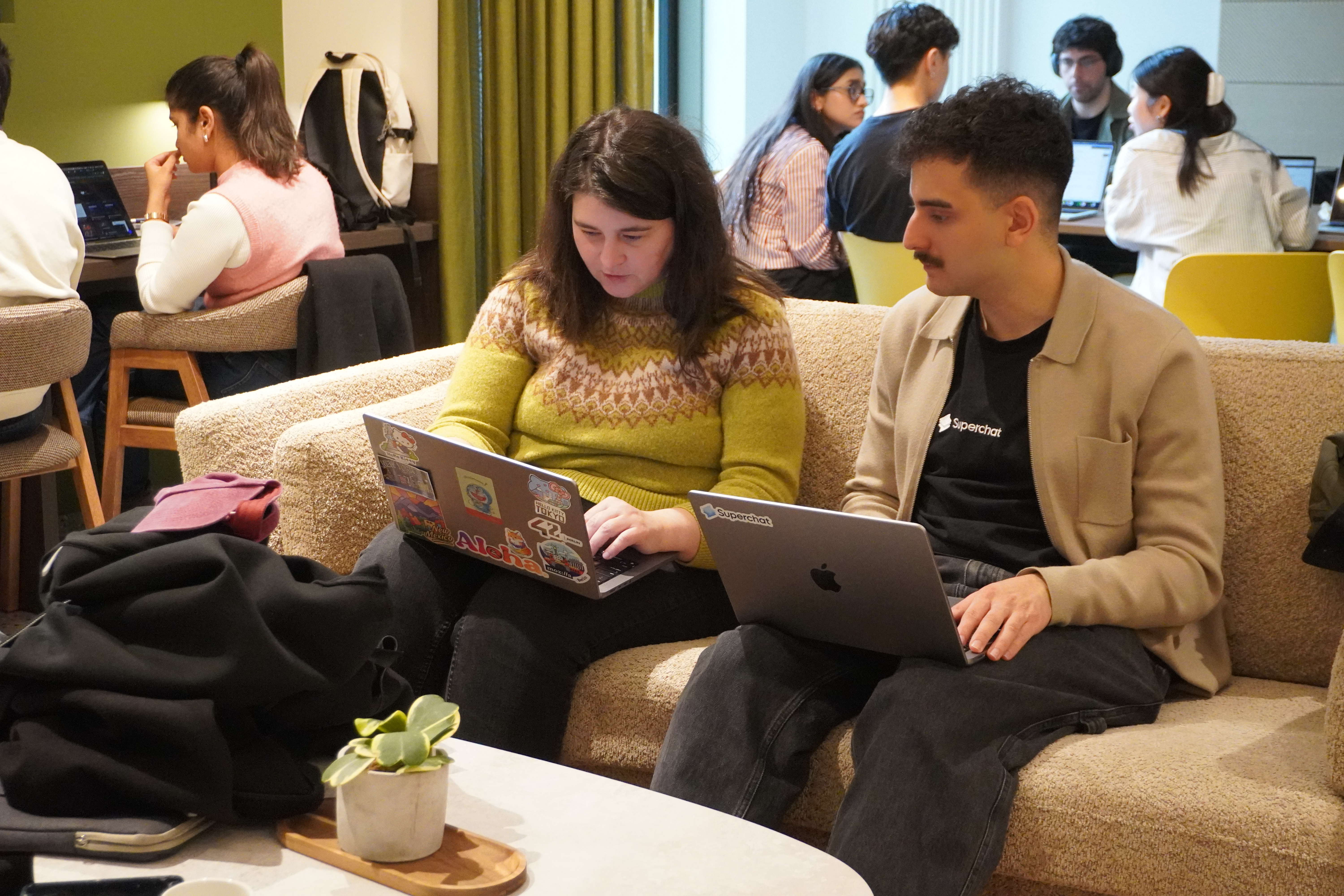 Hackathon participants working together at tables in the venue